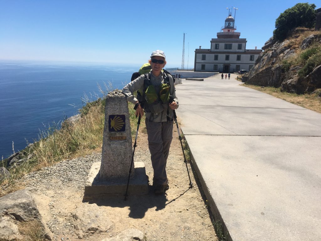 Victoria Osborne leaning on the final milepost in the Camino across Spain