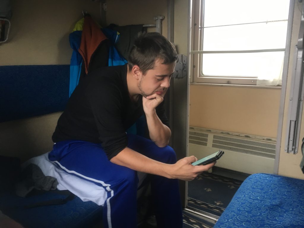 Sil reads a book on his phone