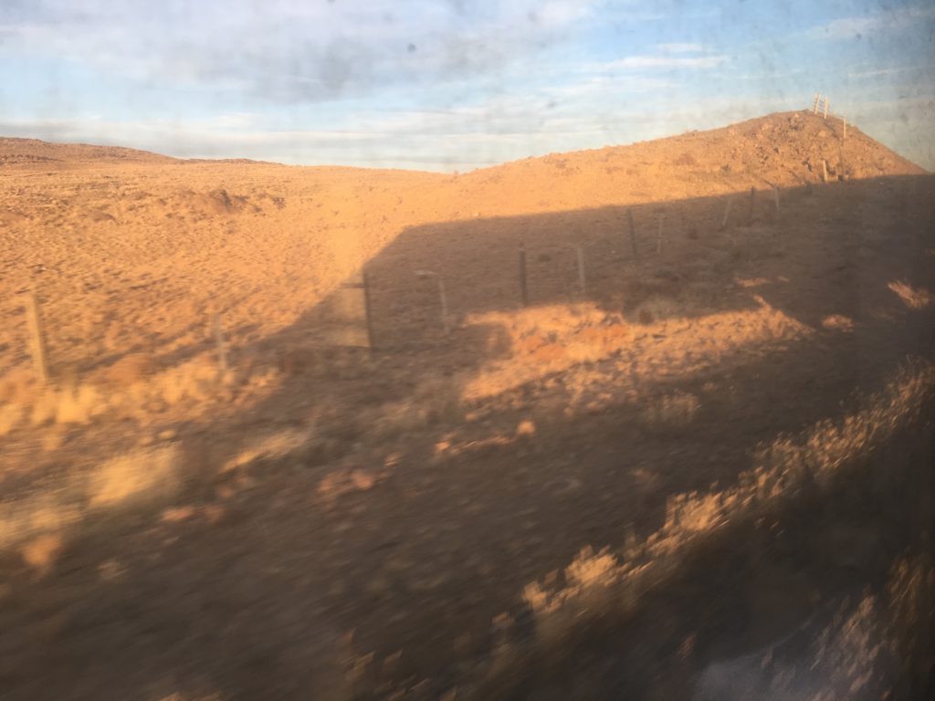 The shadow of our train crests the Mongolian hill