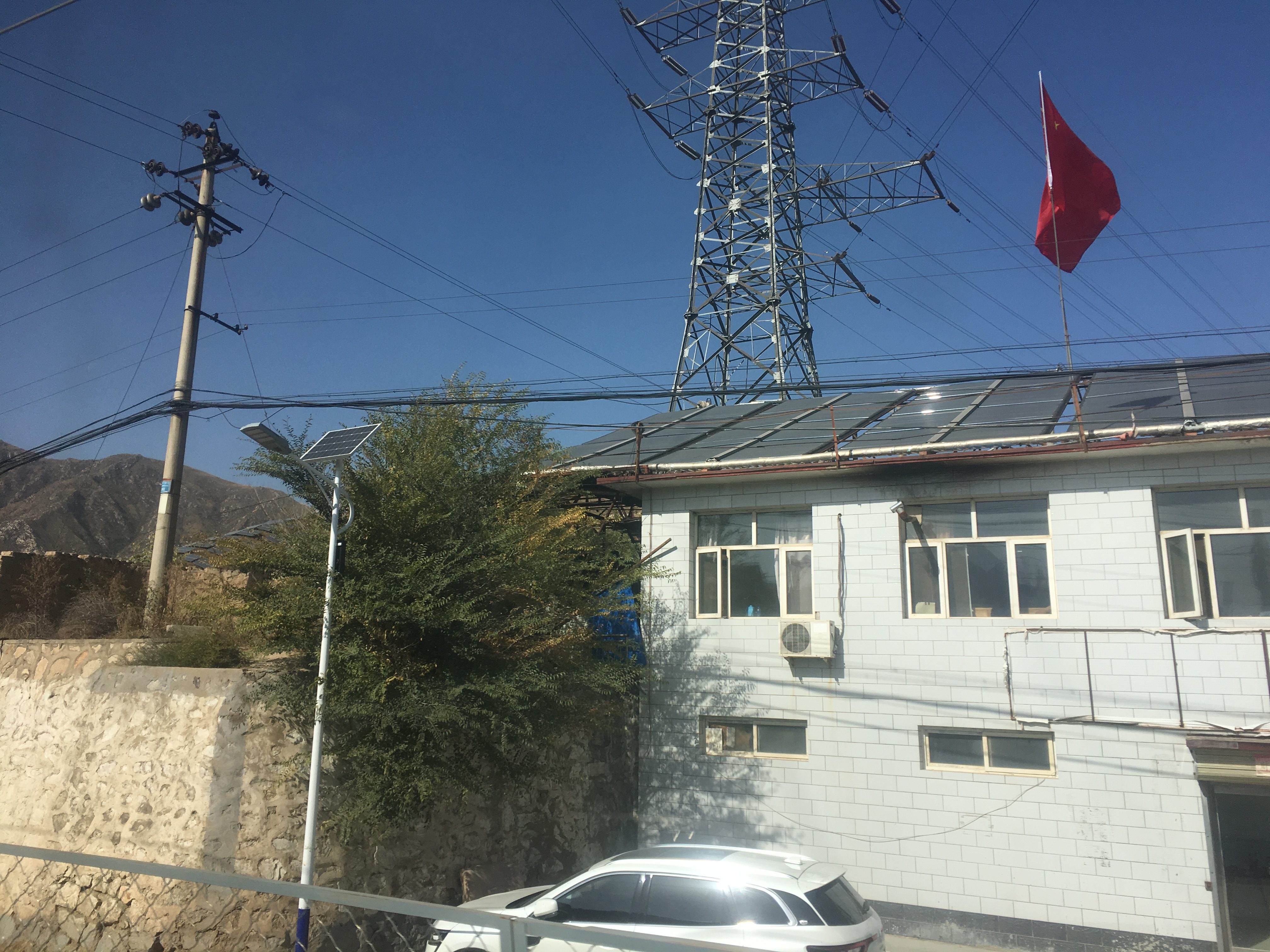 Chinese flag flutters over what could be solar panels
