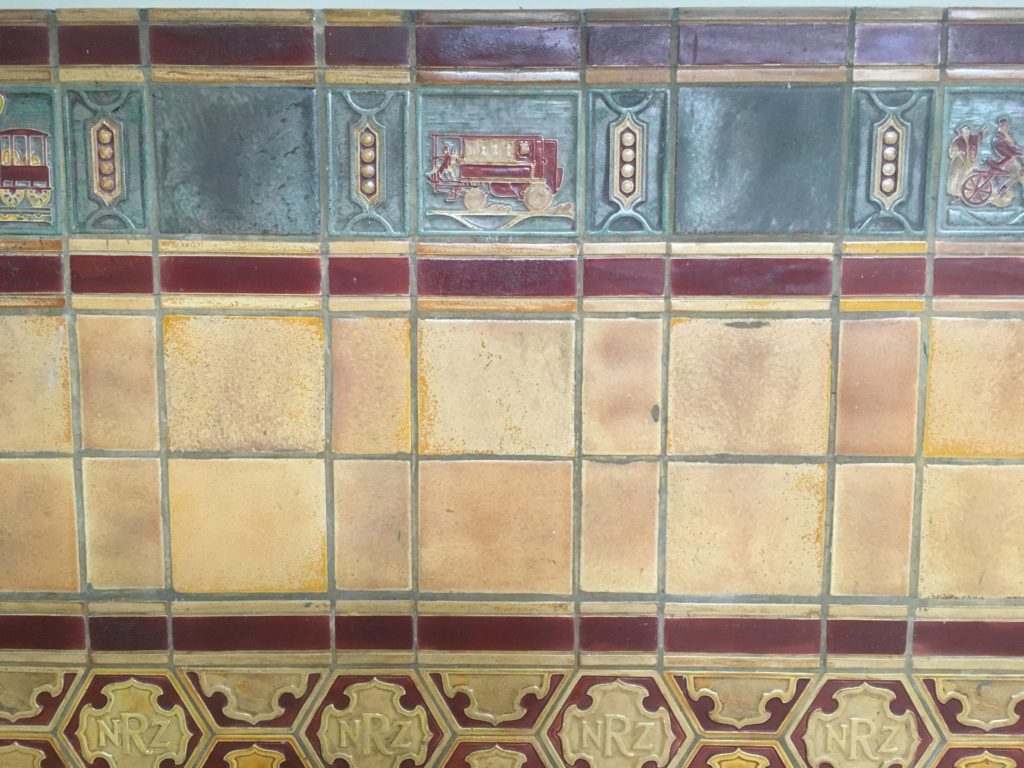 Tiles on the Auckland Central Hotel walls still depict train themes