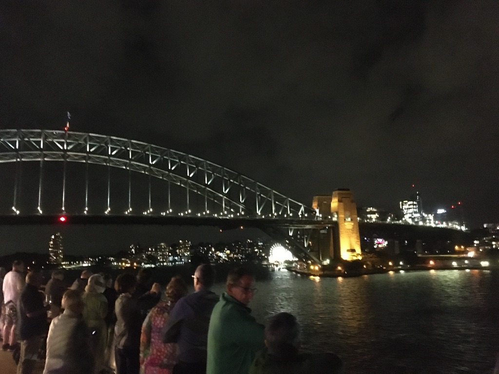 Sydney Harbour Bridge on departure. Bright lights on the shore could be the torches of friends and family on board the QM2