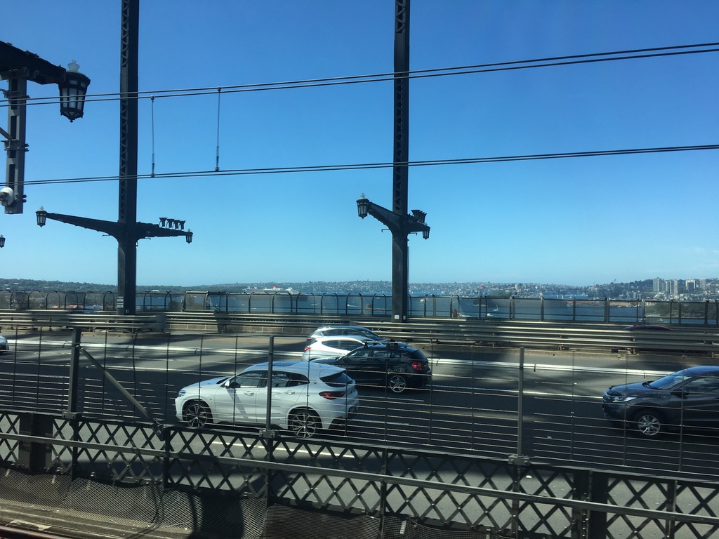 glimpse of QM2 from suburban train on Harbour Bridge