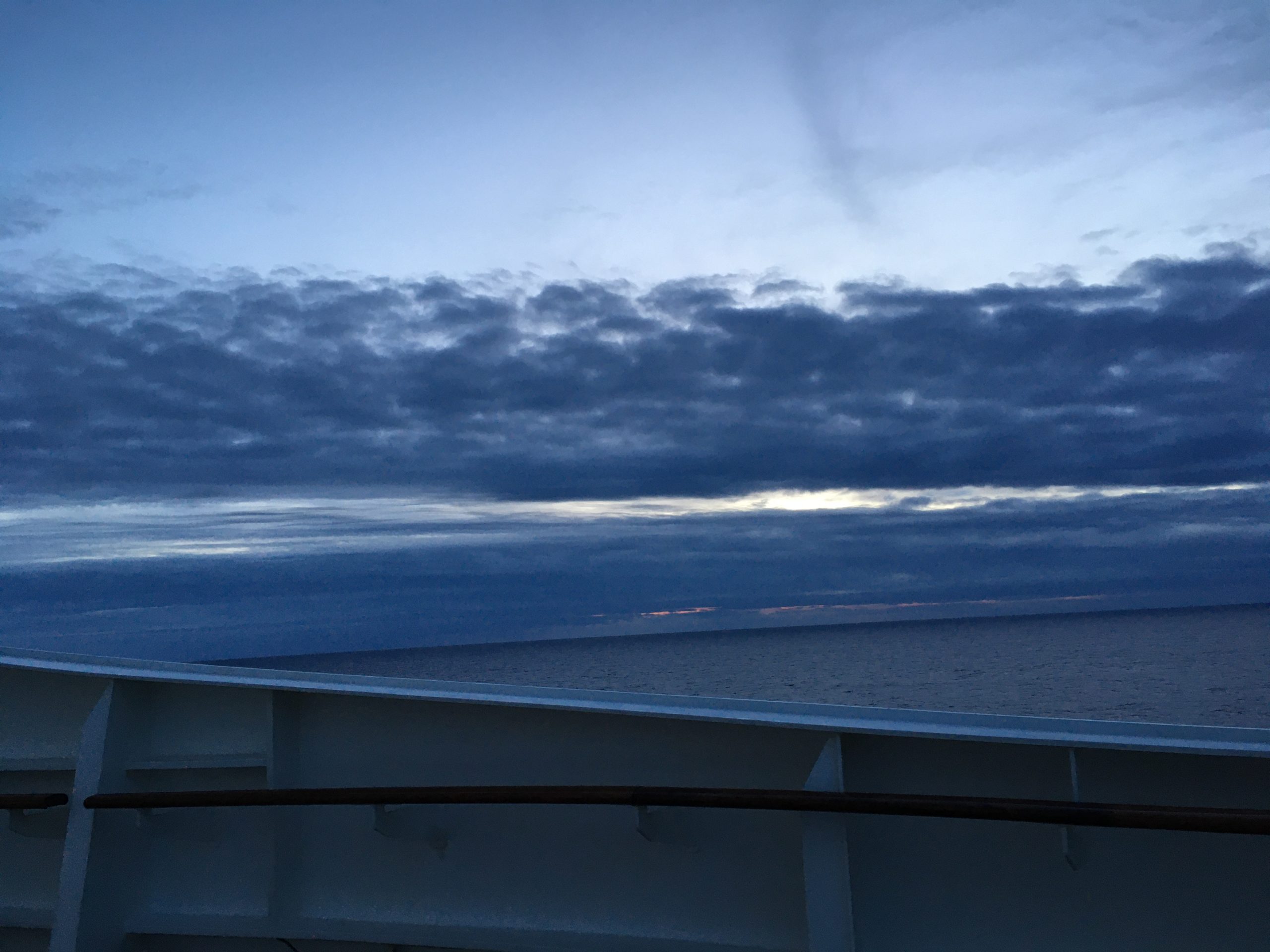 Sky, horizon, sea and QM2 railings attempt to line up at twilight