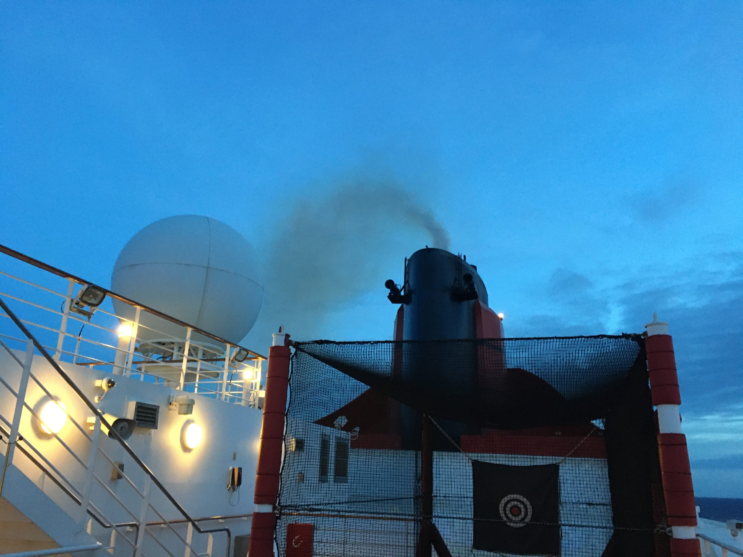 Twilight smoke showing which way the wind is blowing on the QM2